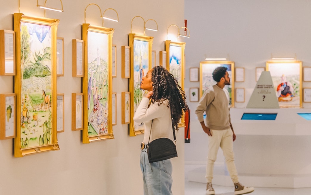Visitors exploring art gallery during The Wine Experience tour.