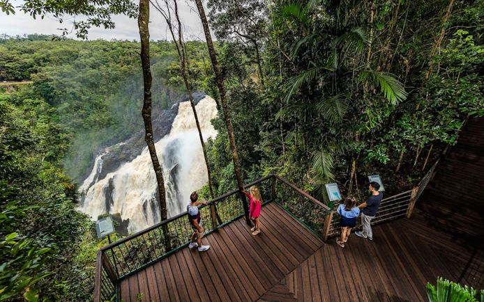 Visitors on a viewing platform overlooking Barron Falls in Kuranda rainforest.