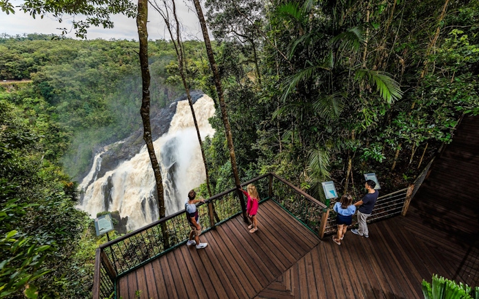 Visitors on a viewing platform overlooking Barron Falls in Kuranda rainforest.