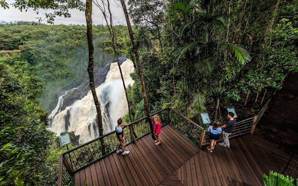 Visitors on a viewing platform overlooking Barron Falls in Kuranda rainforest.