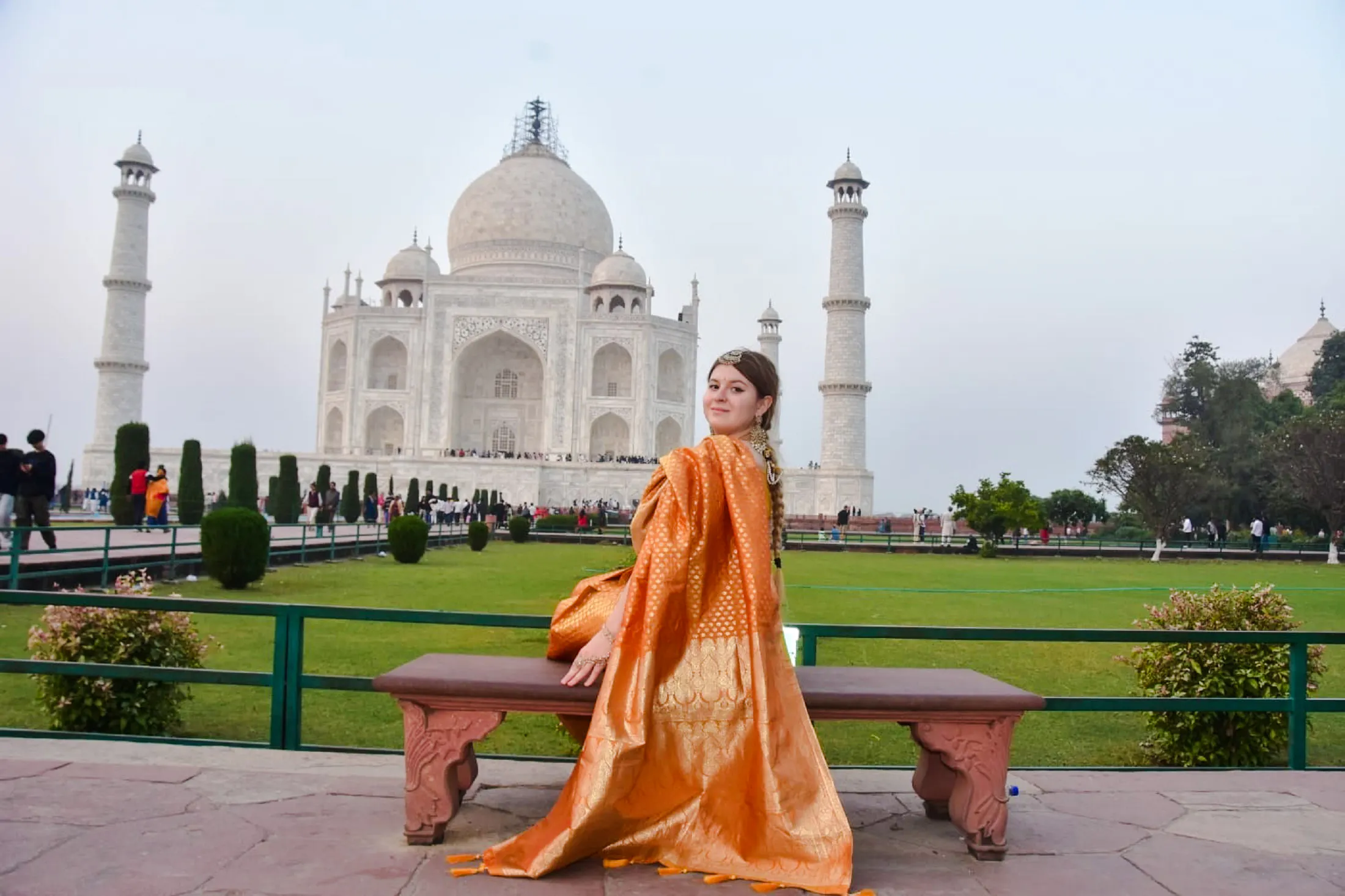 Visitor in traditional attire at the Taj Mahal, part of a private day trip from Delhi to Agra.
