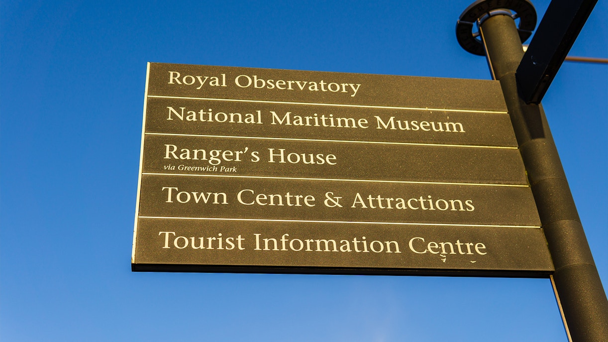 Signpost with directions to Royal Observatory, National Maritime Museum, and Greenwich attractions.