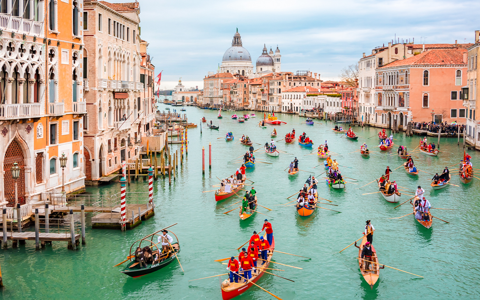 Gondola boats in water parade during Venice carnival opening.