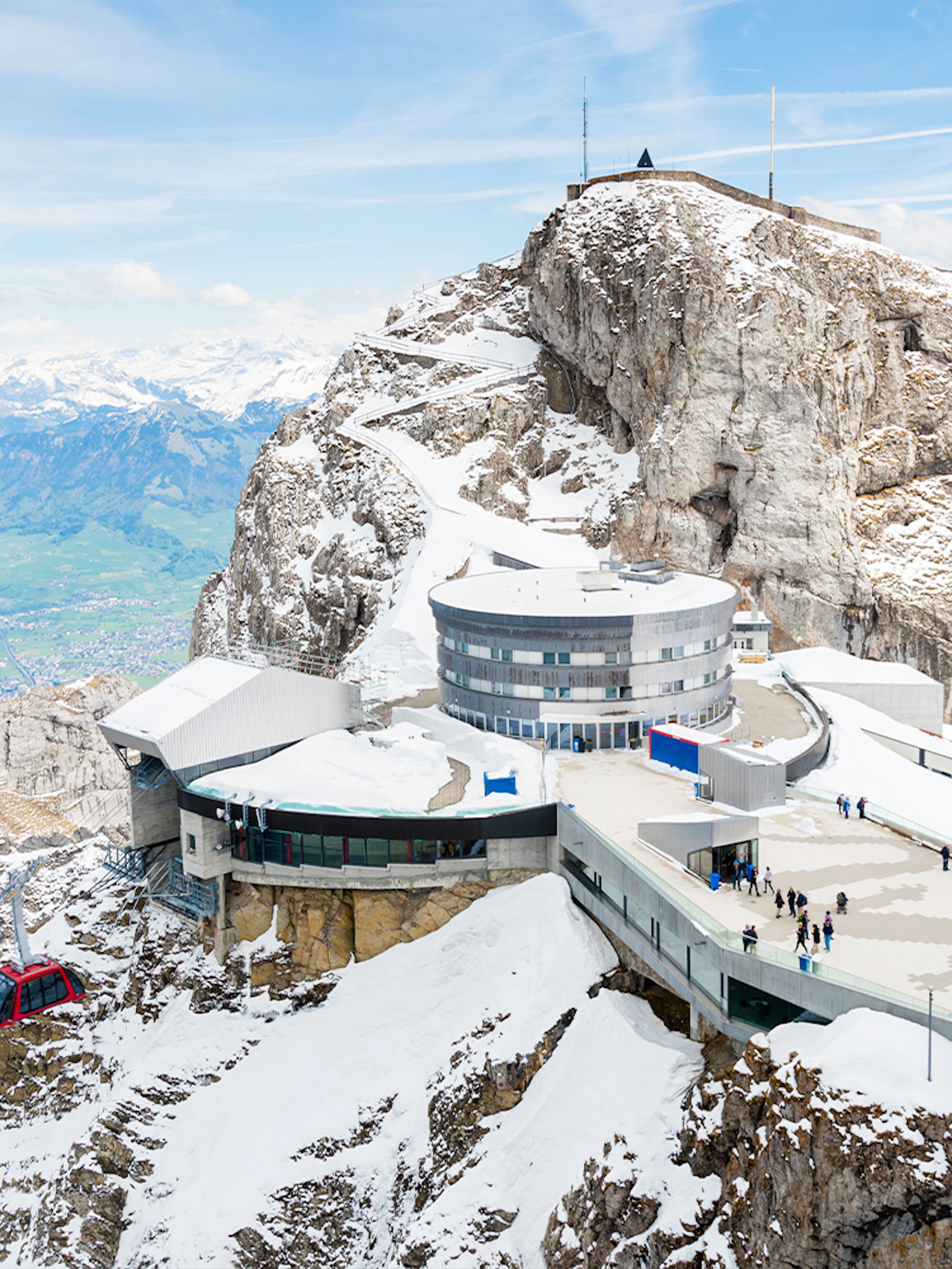Mount Pilatus summit with visitors and cable car, overlooking Lake Lucerne, Switzerland.