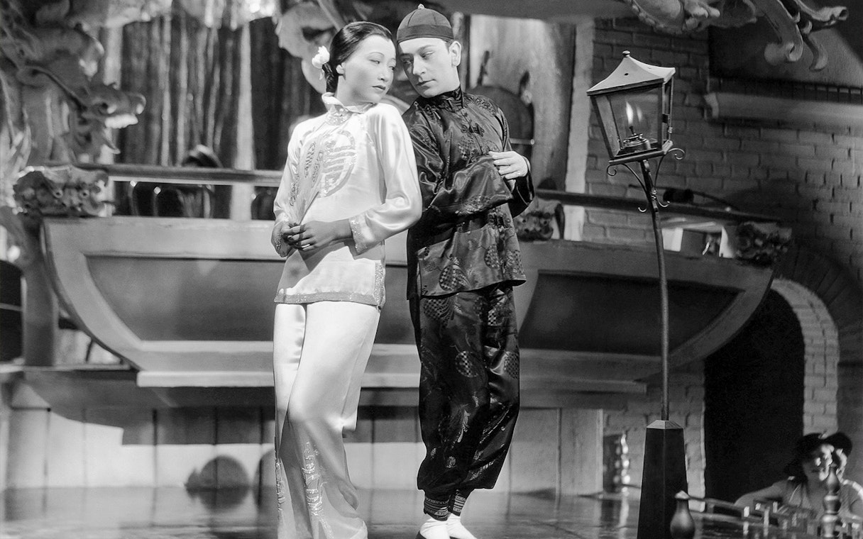 Two performers in traditional attire on stage at Singapore Future World Exhibition.