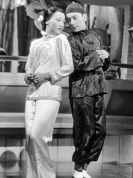 Two performers in traditional attire on stage at Singapore Future World Exhibition.