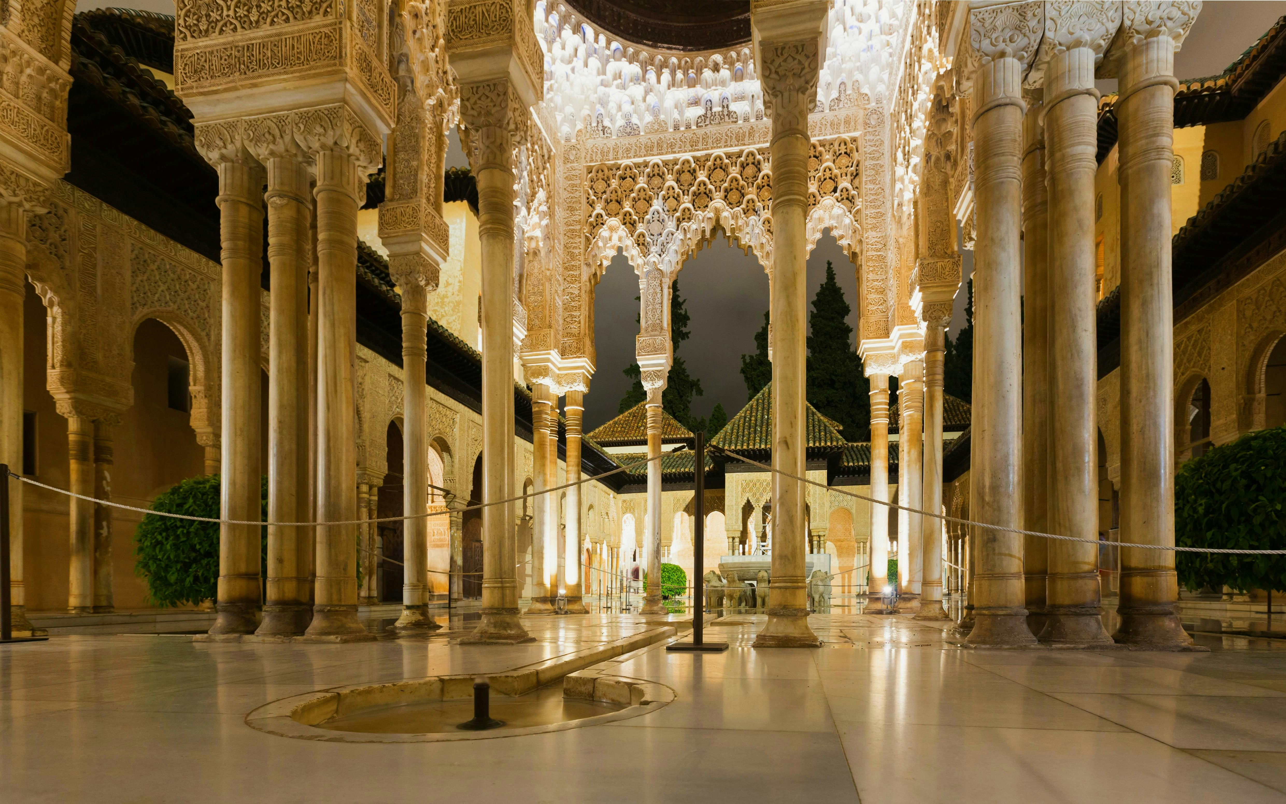 Courtyard of the Lions illuminated at night, Alhambra, Granada, Spain.
