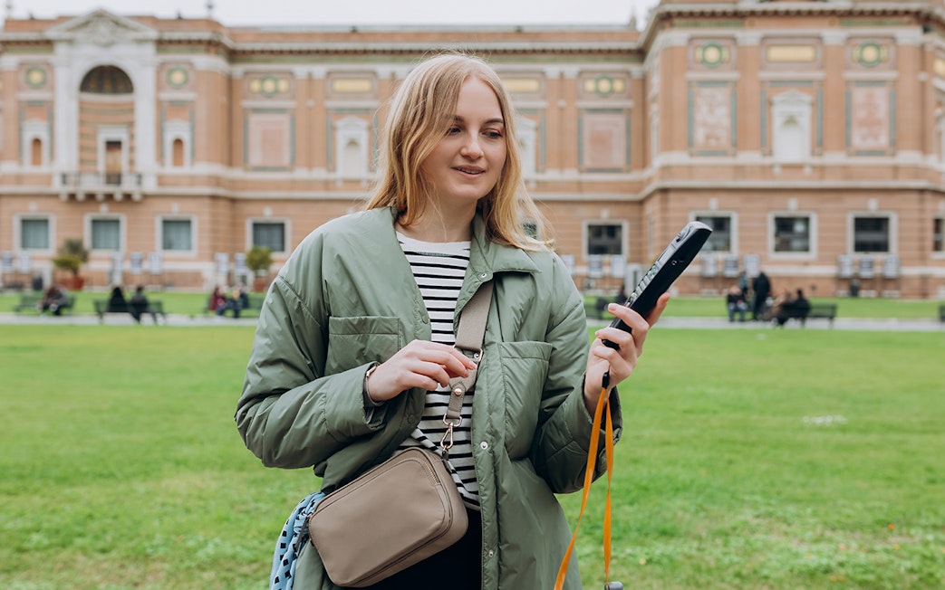 Tourist with audio guide in Vatican Gardens near Vatican Museums.