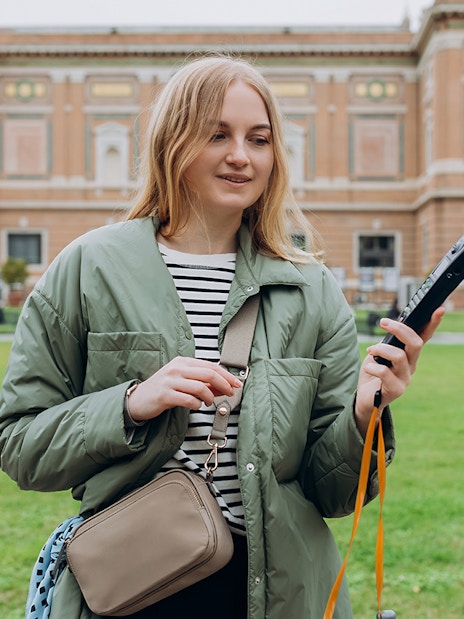 Tourist with audio guide in Vatican Gardens near Vatican Museums.