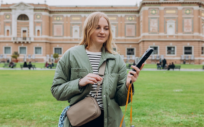 Tourist with audio guide in Vatican Gardens near Vatican Museums.