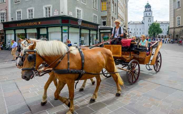 Horse-drawn carriage tour in Salzburg city center, Austria.