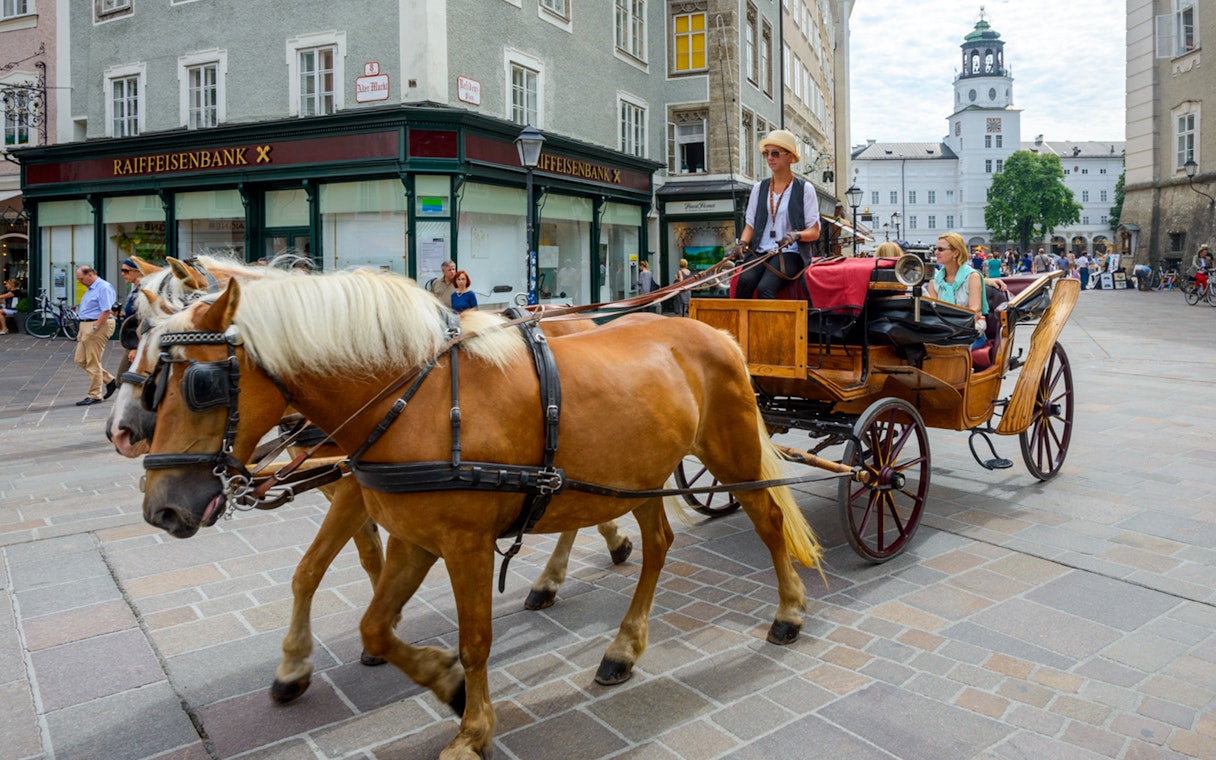 Horse-drawn carriage tour in Salzburg city center, Austria.