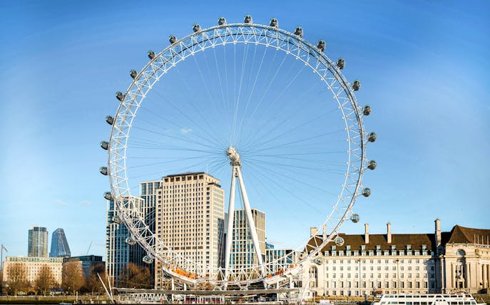 London Eye with city skyline in the background, part of combo tour with Madame Tussauds and SEA LIFE.