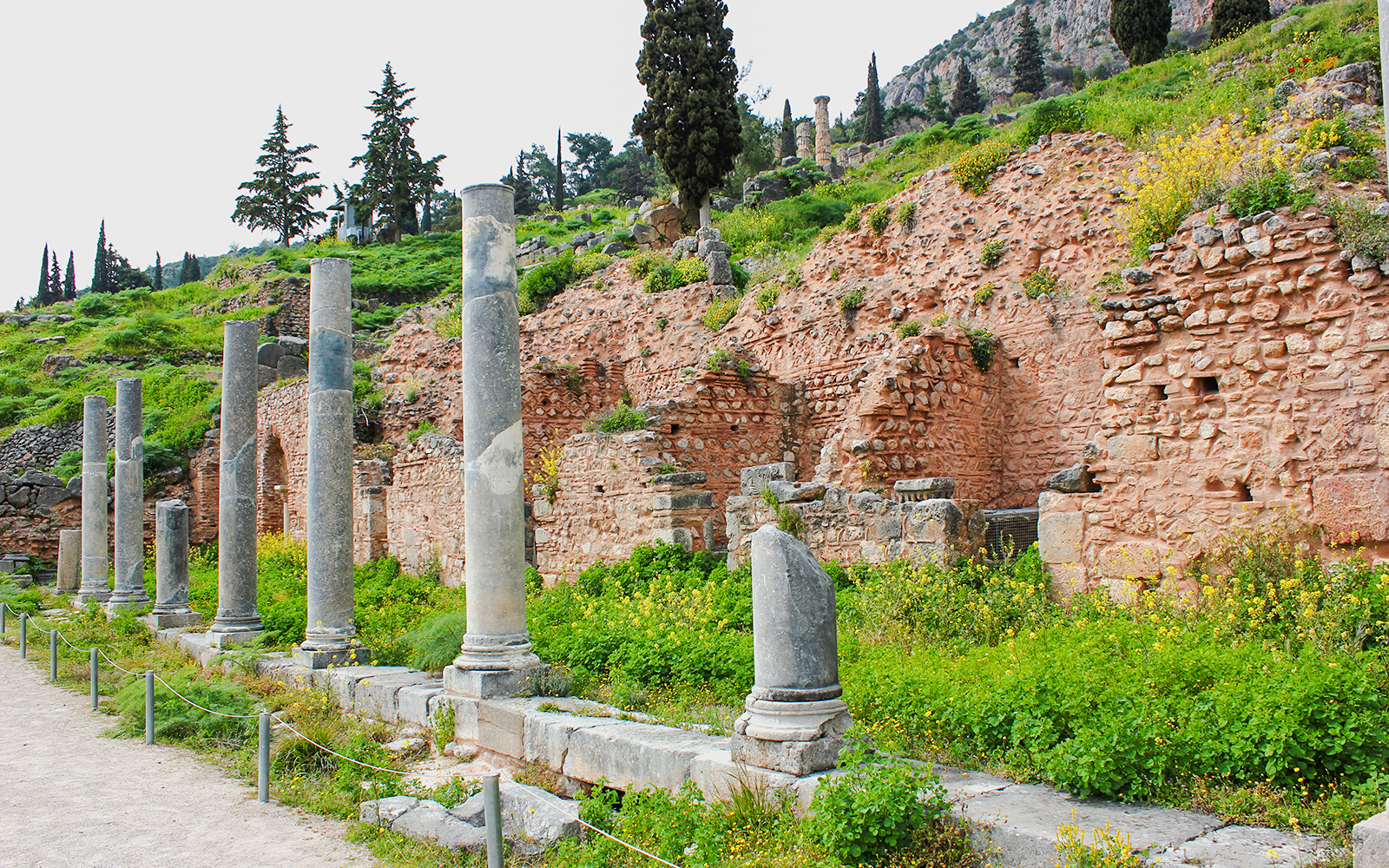 Ancient columns and ruins of the Stoa of the Athenians at Delphi, Greece.
