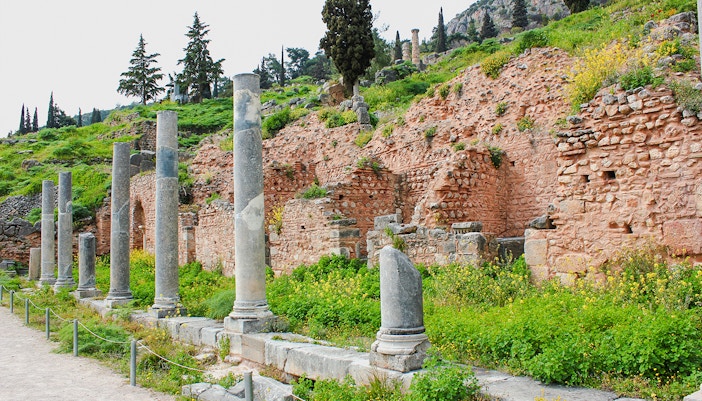 Ancient columns and ruins of the Stoa of the Athenians at Delphi, Greece.