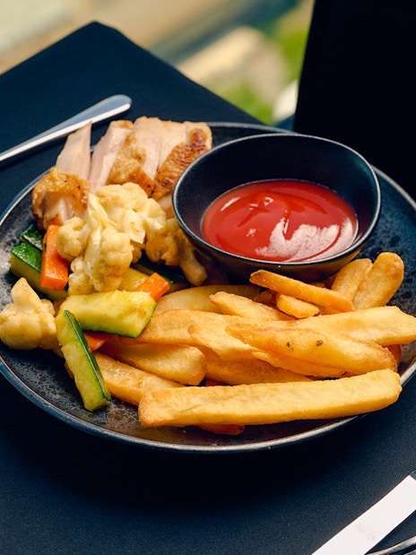 Children's menu with fries and vegetables at Melbourne Skydeck dining experience.