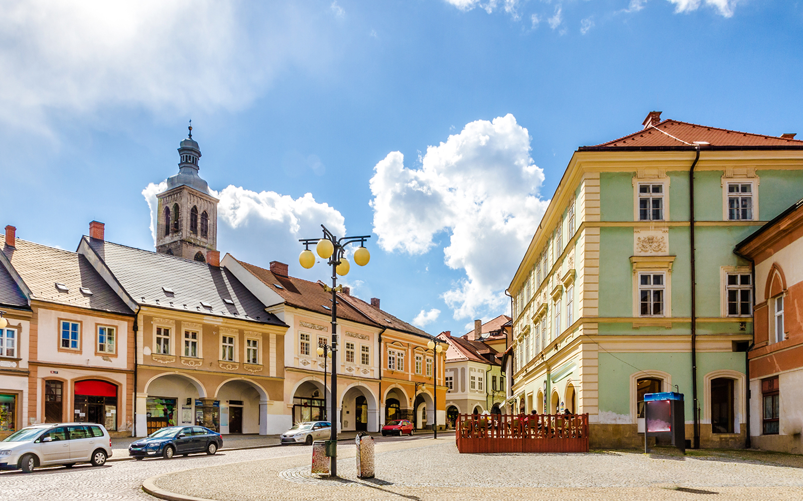 Palacky Square with historic buildings and church tower in Kutna Hora.