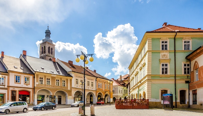 Palacky Square with historic buildings and church tower in Kutna Hora.