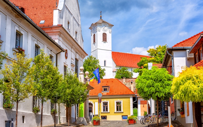 Colorful buildings and church tower in Szentendre, Hungary, along the Budapest to Szentendre tour route.
