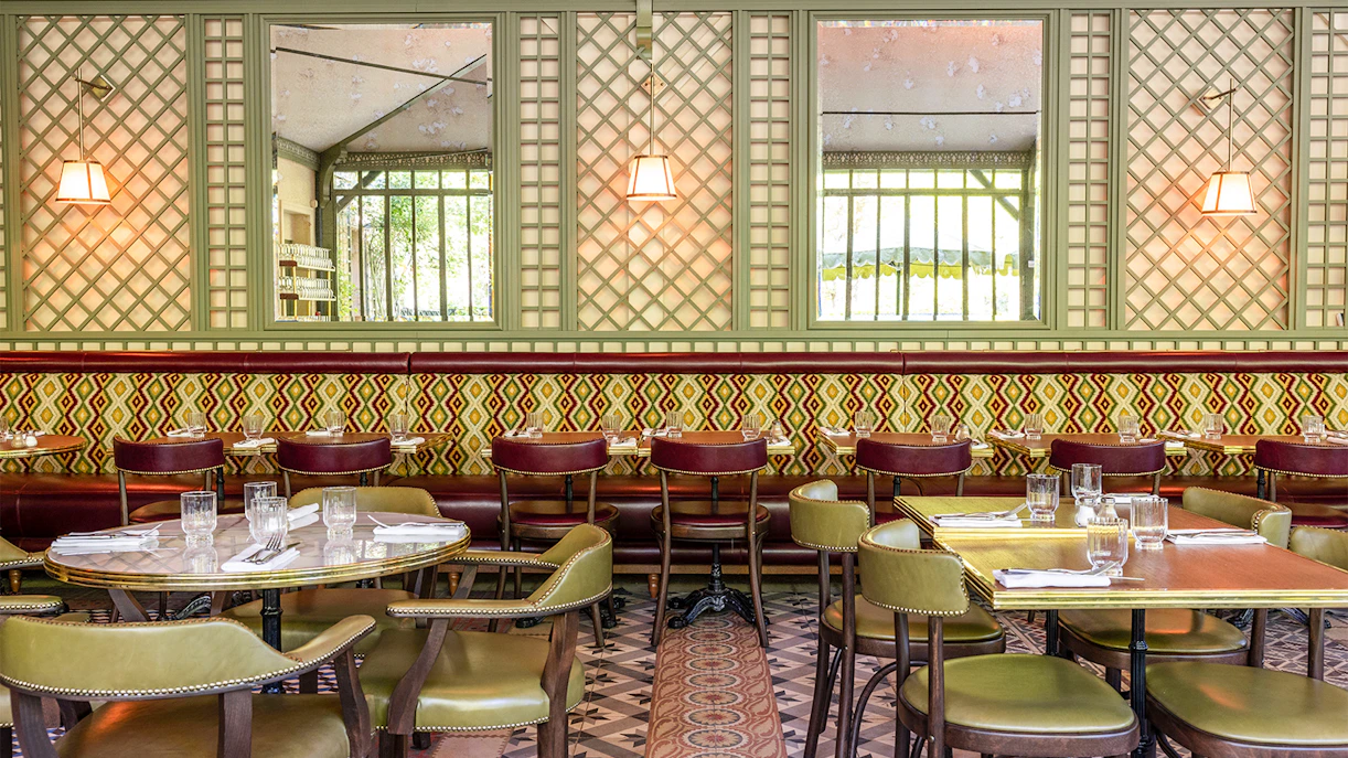 Dining area at La Flottille restaurant with set tables and patterned decor.