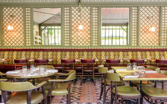 Dining area at La Flottille restaurant with set tables and patterned decor.