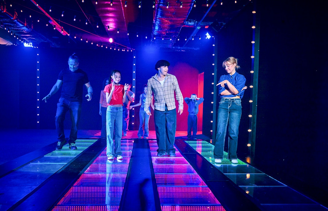 Participants navigating a glass bridge at the Squid Games experience in London.
