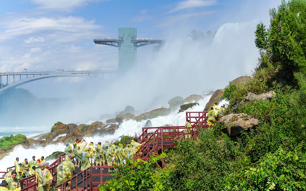 Visitors in yellow ponchos on the Cave of the Winds tour near Niagara Falls.