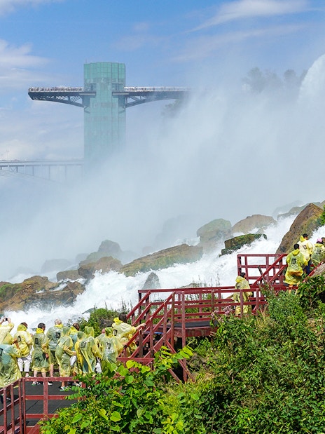 Visitors in yellow ponchos on the Cave of the Winds tour near Niagara Falls.