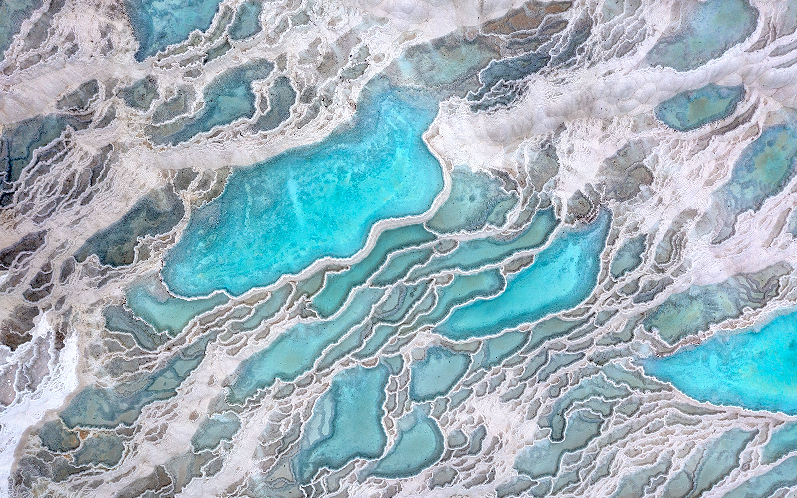 Aerial view of Pamukkale's turquoise thermal pools and travertine terraces.