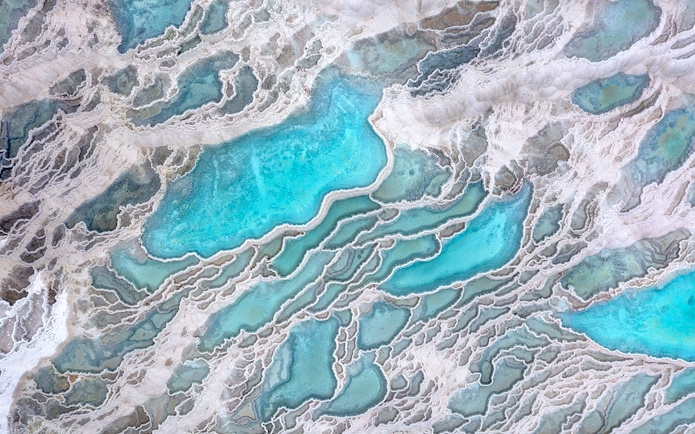 Aerial view of Pamukkale's turquoise thermal pools and travertine terraces.