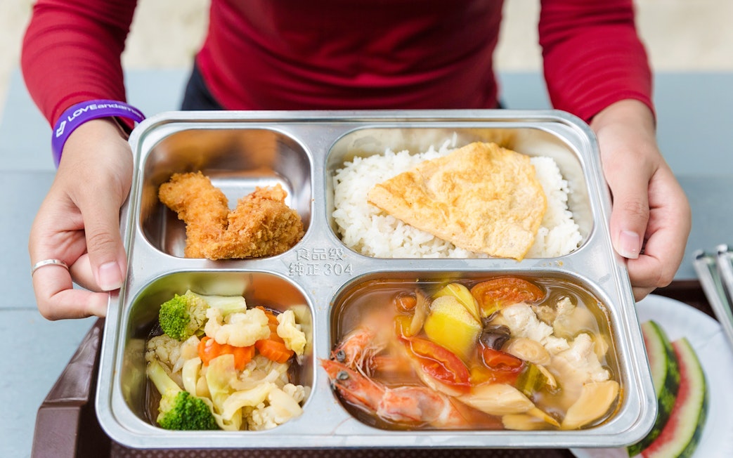 Buffet meal with rice, fried chicken, vegetables, and seafood soup on Similan Island.