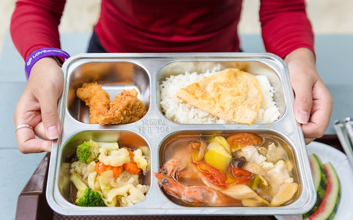 Buffet meal with rice, fried chicken, vegetables, and seafood soup on Similan Island.