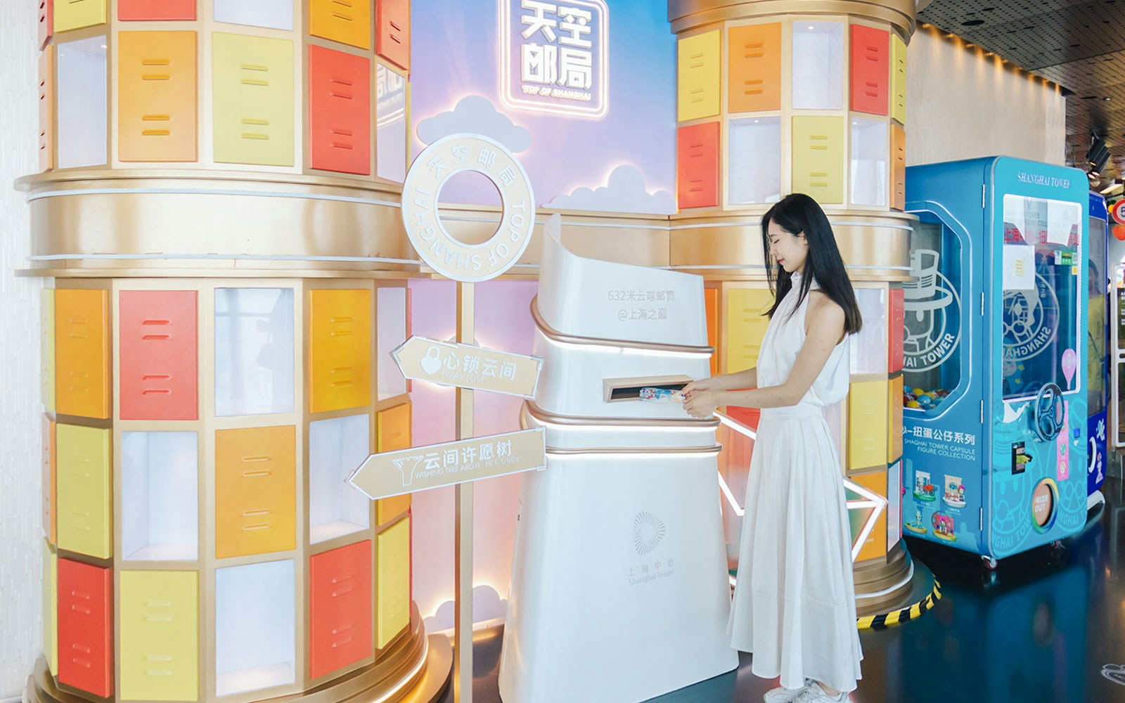 Woman interacting with a colorful display at Shanghai Tower's observation deck.