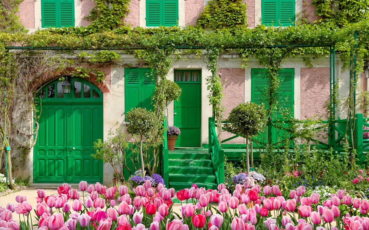 Monet's House with pink tulips in Giverny, France, on a half-day tour from Paris.
