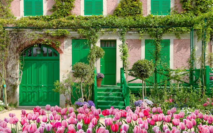 Monet's House with pink tulips in Giverny, France, on a half-day tour from Paris.