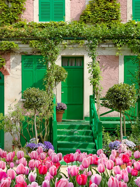 Monet's House with pink tulips in Giverny, France, on a half-day tour from Paris.