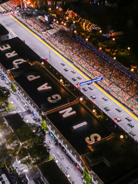 Aerial view of illuminated Formula 1 track at night during Singapore Grand Prix.