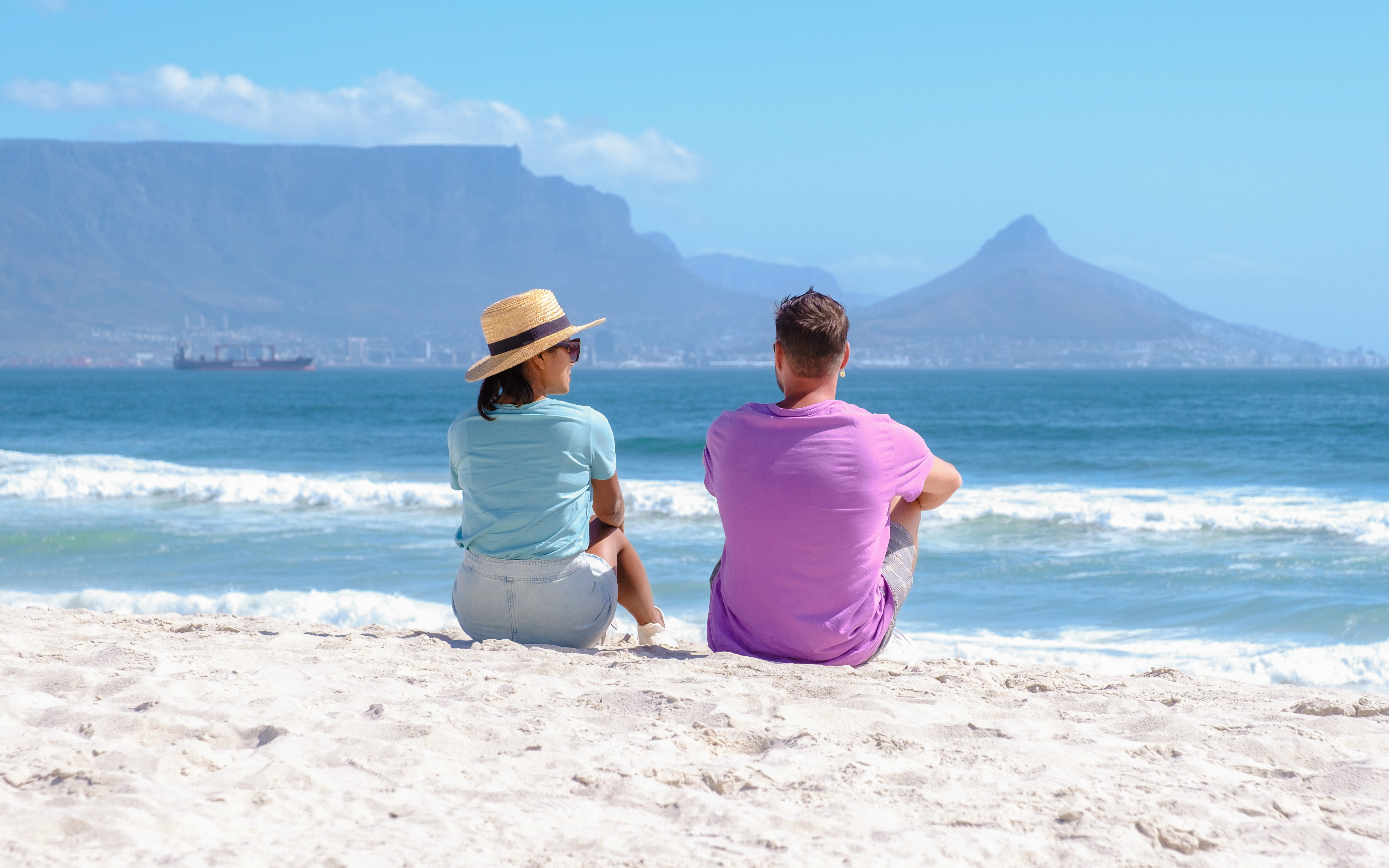 Couple at beach in Cape Town South Africa on a bright summer day