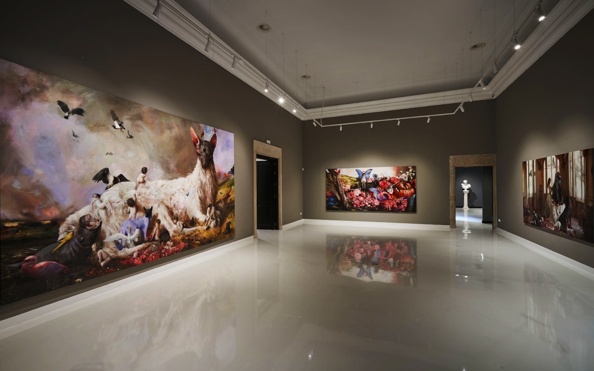 Contemporary art gallery at Moco Museum, Barcelona, featuring large colorful paintings.