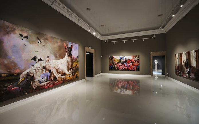 Contemporary art gallery at Moco Museum, Barcelona, featuring large colorful paintings.