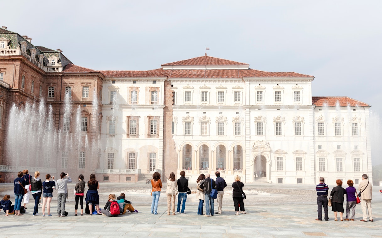 Tourists viewing fountains at Palace of Venaria Reale, a royal residence near Turin, Piedmont.