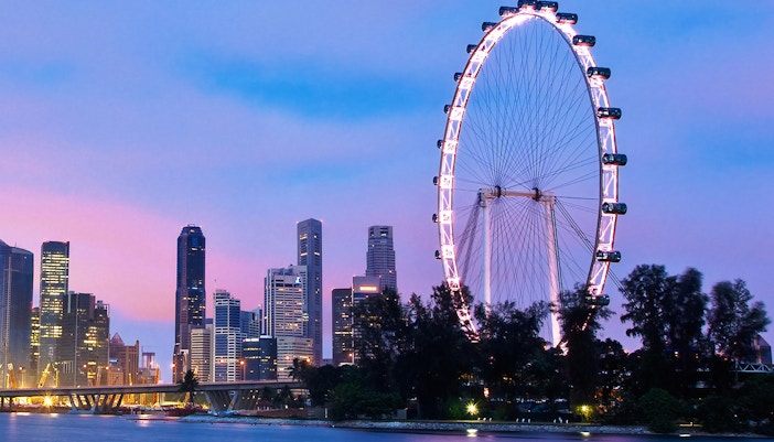 Singapore Flyer capsule with dining setup overlooking city skyline.