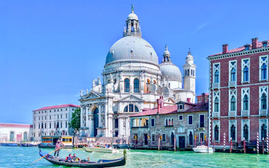 Gondola on Venice canal near Santa Maria della Salute basilica.