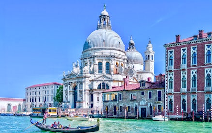 Gondola on Venice canal near Santa Maria della Salute basilica.