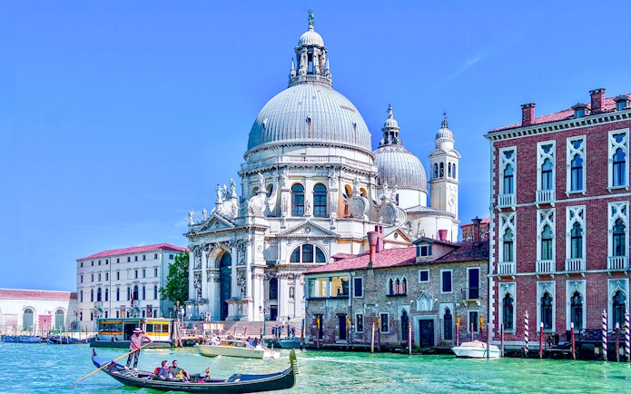 Gondola on Venice canal near Santa Maria della Salute basilica.