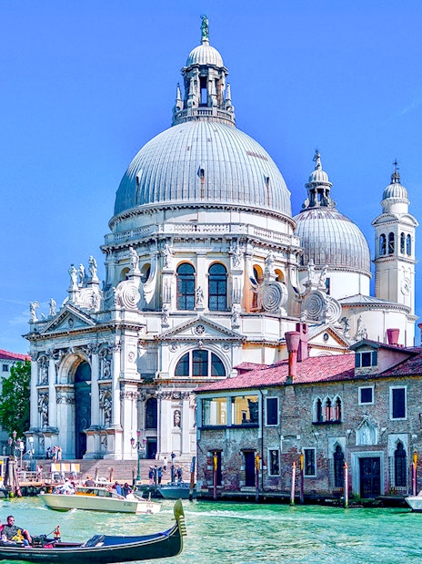 Gondola on Venice canal near Santa Maria della Salute basilica.