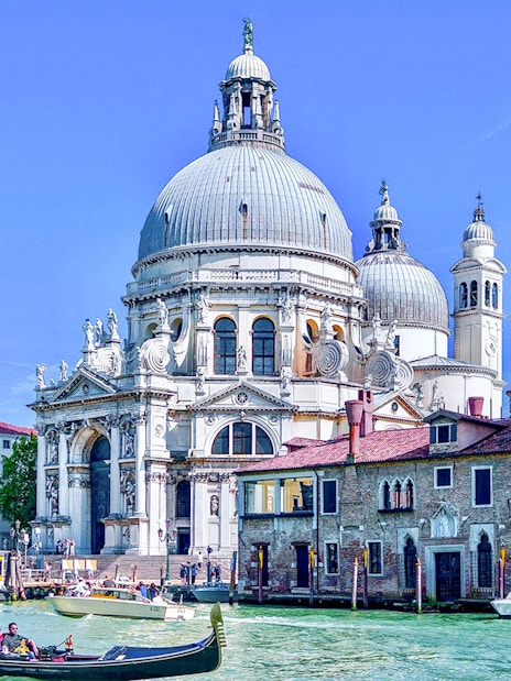 Gondola on Venice canal near Santa Maria della Salute basilica.