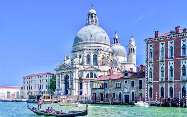 Gondola on Venice canal near Santa Maria della Salute basilica.