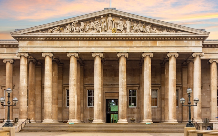 Main entrance of the British Museum with neoclassical columns in London, UK.