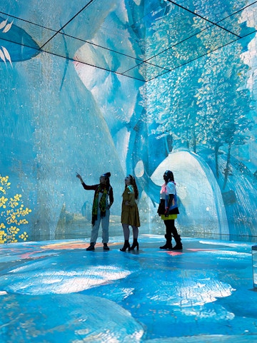 Visitors exploring immersive art installation at Frameless London.